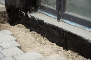 basement and foundations repair by insulating the basement concrete wall.