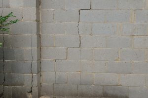 Cracked exterior brick wall indicating potential foundation issues, relevant to foundation repair methods and stabilization techniques.