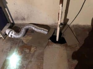 Basement waterproofing system featuring a sump pump and drainage pipe, illustrating essential repairs for preventing water damage.