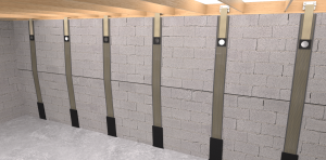 Basement with gray concrete block walls, reinforced by vertical carbon fiber straps evenly spaced. The floor is concrete, and the ceiling is wooden beams.